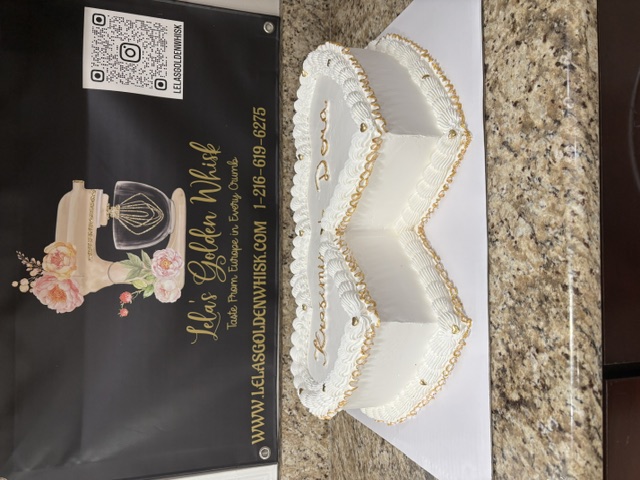 Double heart cake on display with gold beaded piping