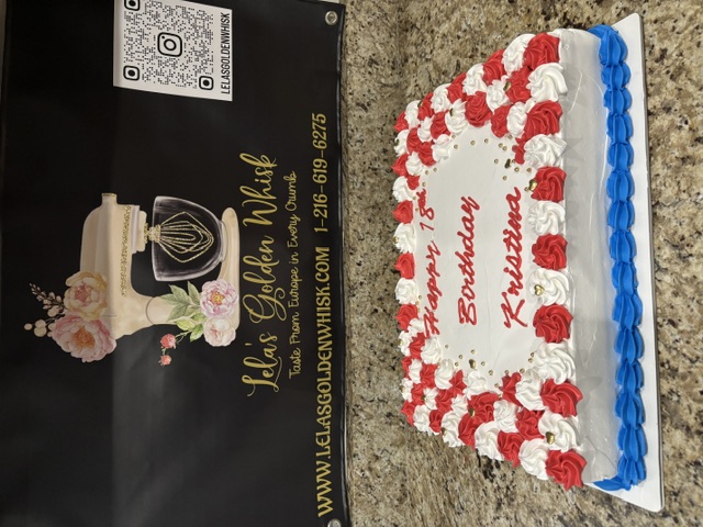 White cake with red rosettes and a blue border