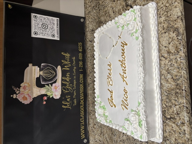 White cake with a piped rosary and cross design