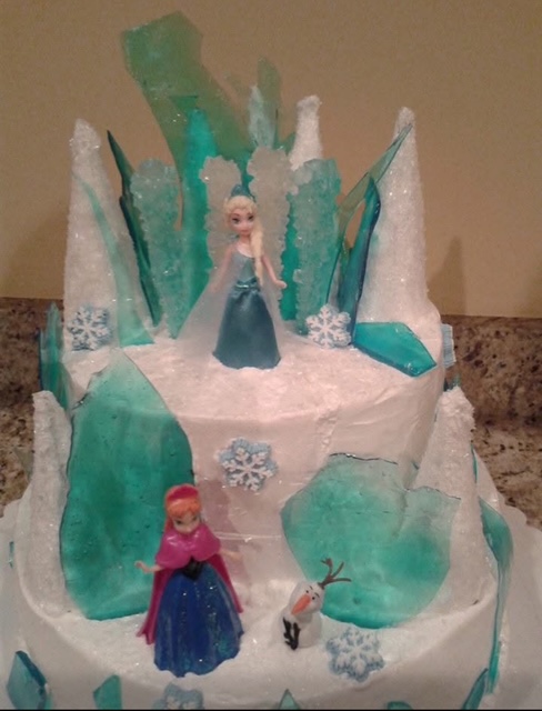 Frozen-themed tiered cake with icy blue decorations