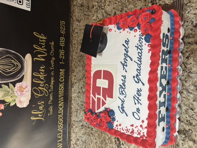 White sheet cake with a Flyers graduation design