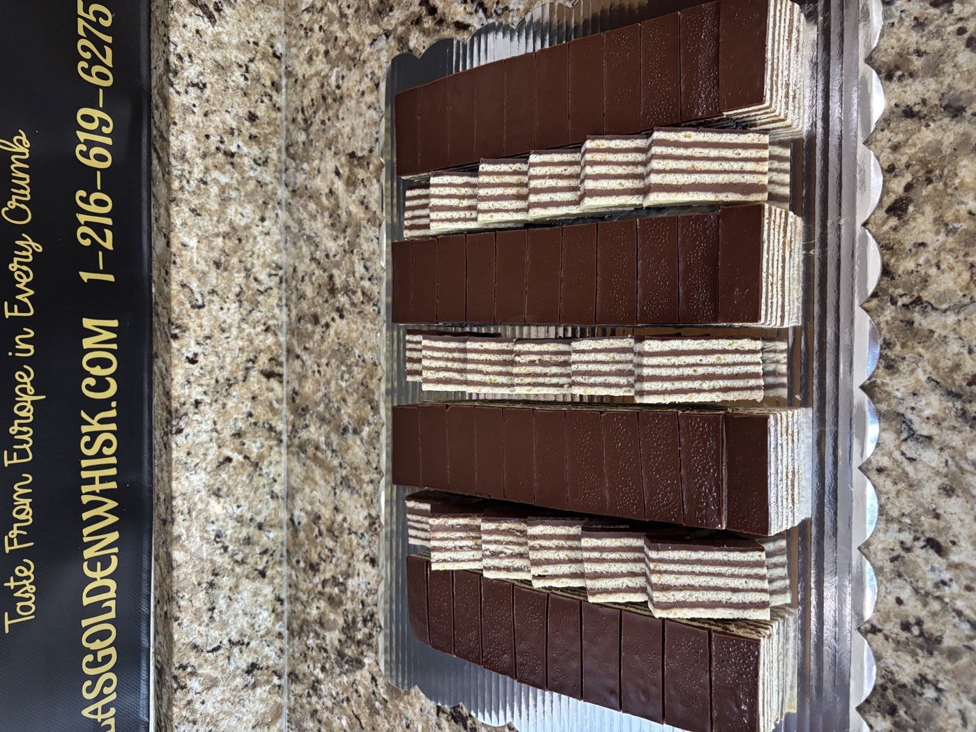Chocolate-glazed layered pastries arranged in rows
