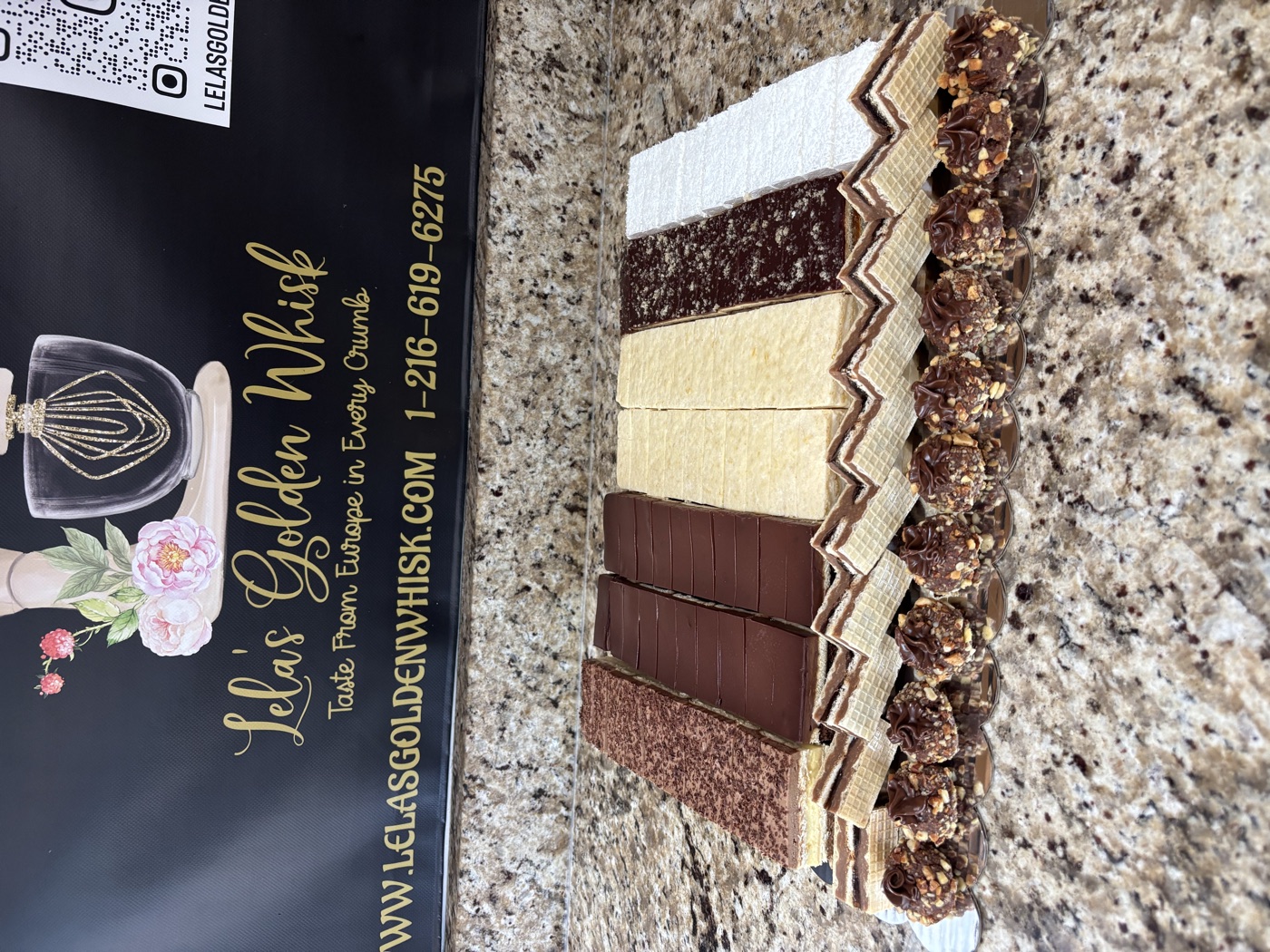 A platter of chocolate and cream layered pastries