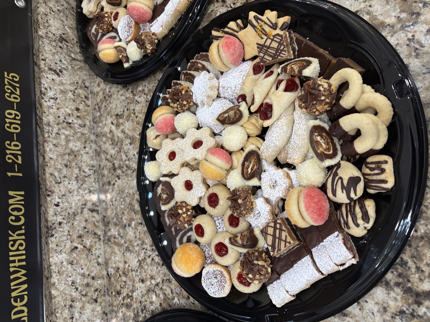 A round tray filled with assorted decorated cookies