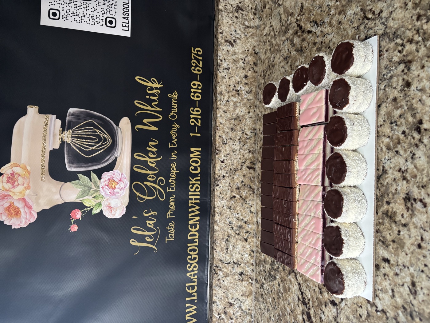 Chocolate-topped pastries and coconut-covered sweets on a platter