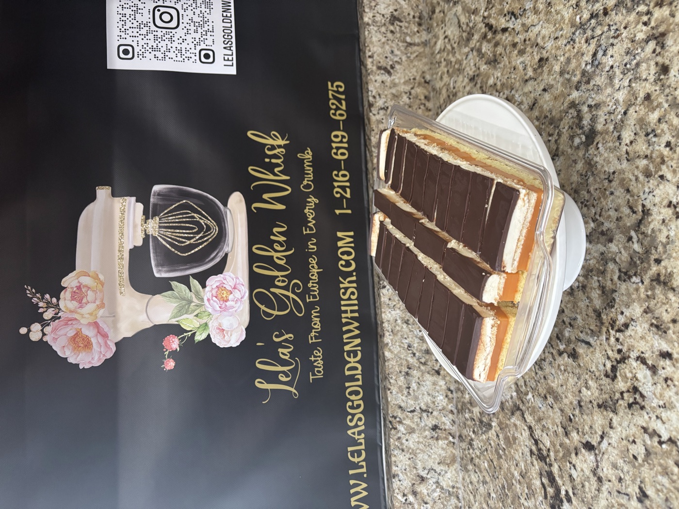 Two chocolate-topped layered cake slices on a plate