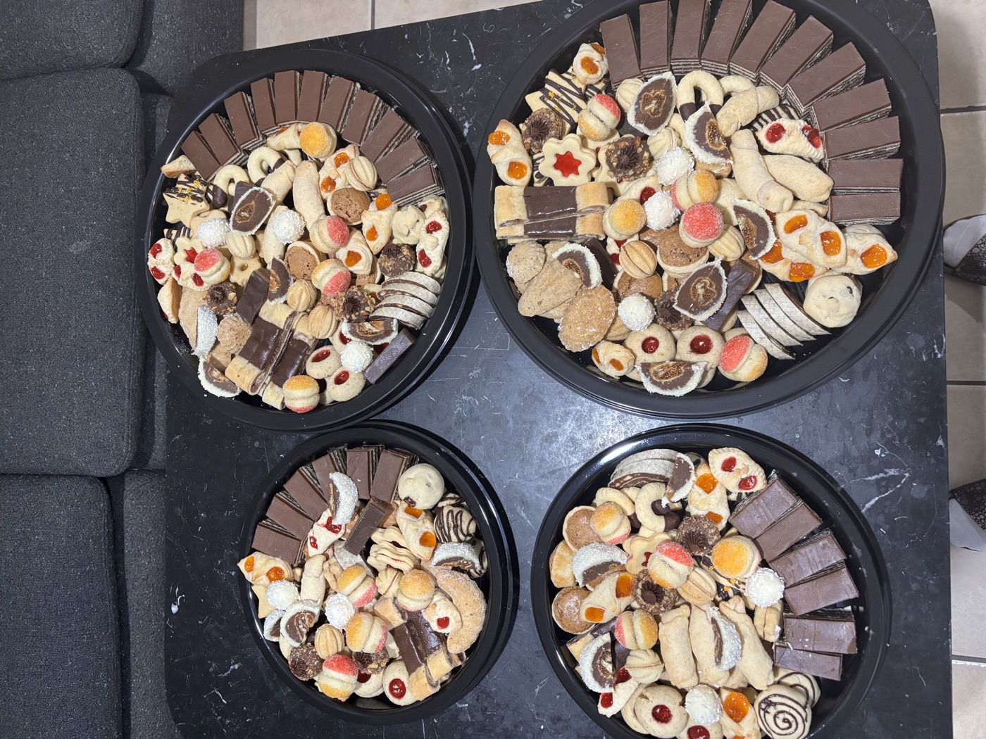 Four trays of assorted cookies ready for an occasion