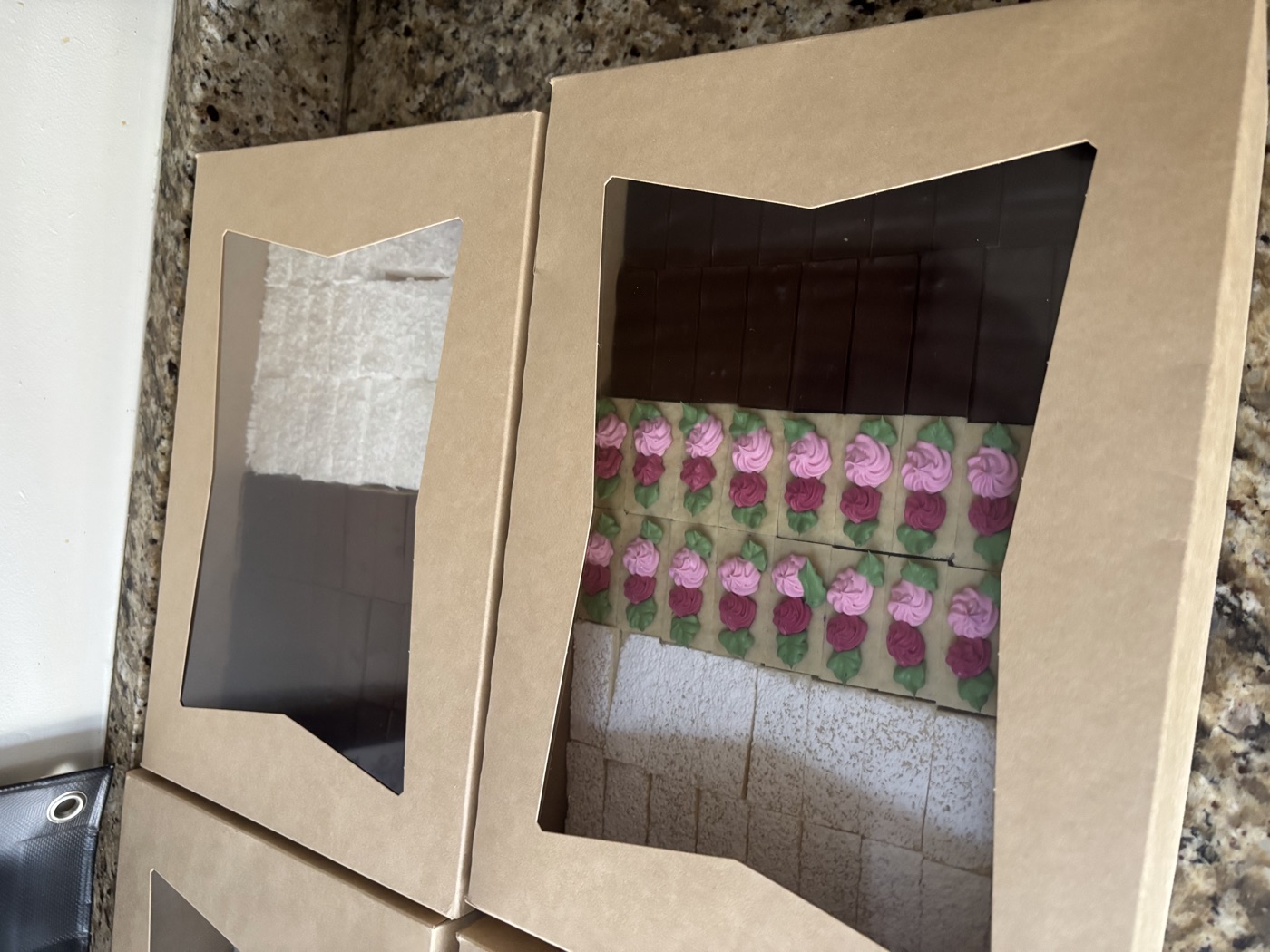 Windowed boxes of colorful layered pastries