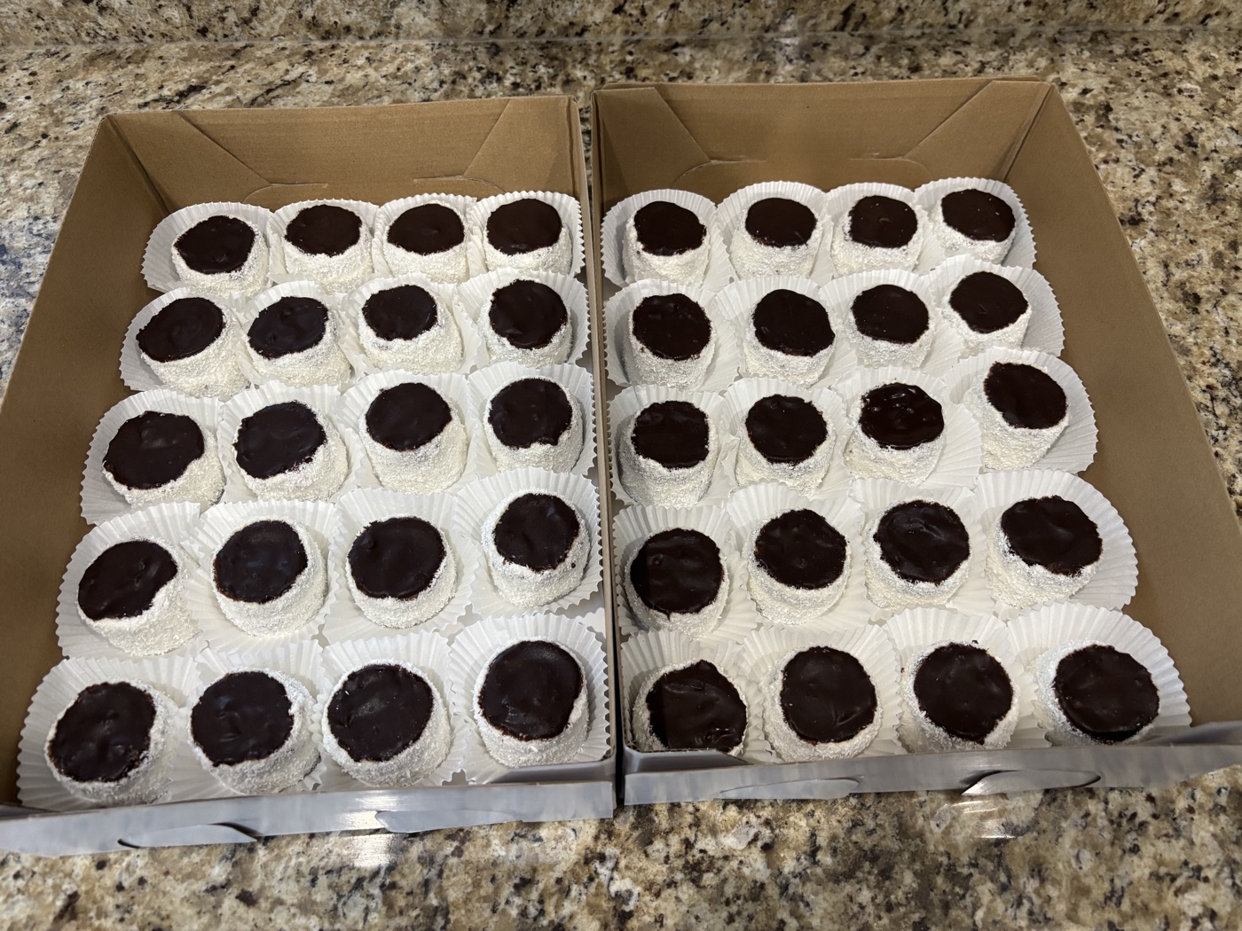 Two boxes of coconut-covered chocolate sweets