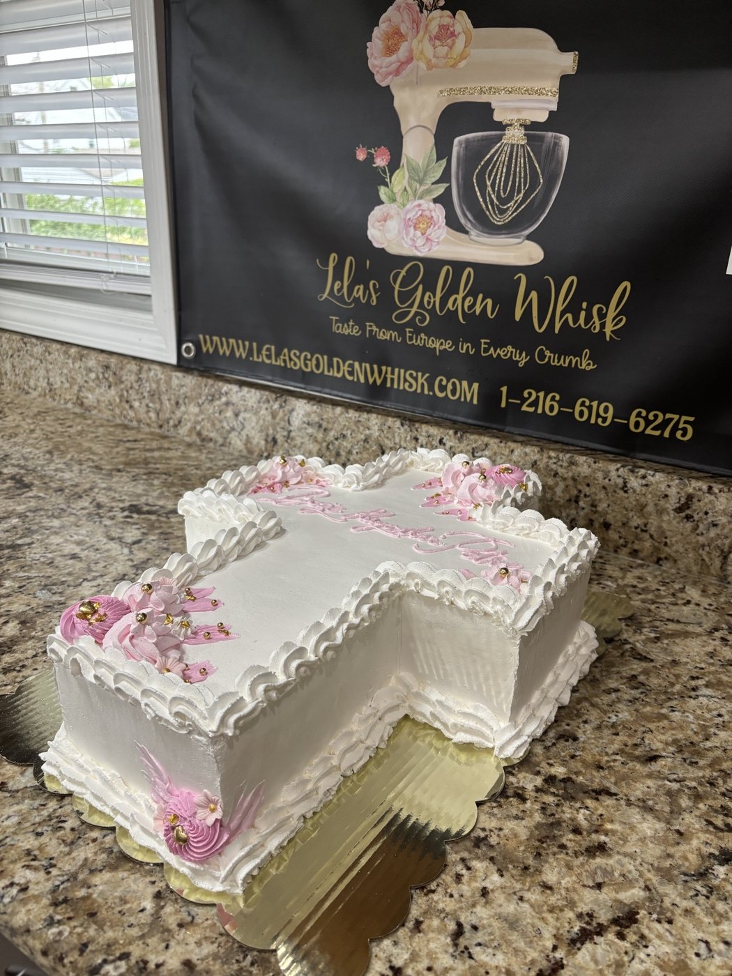 A slice cut from a floral sheet cake
