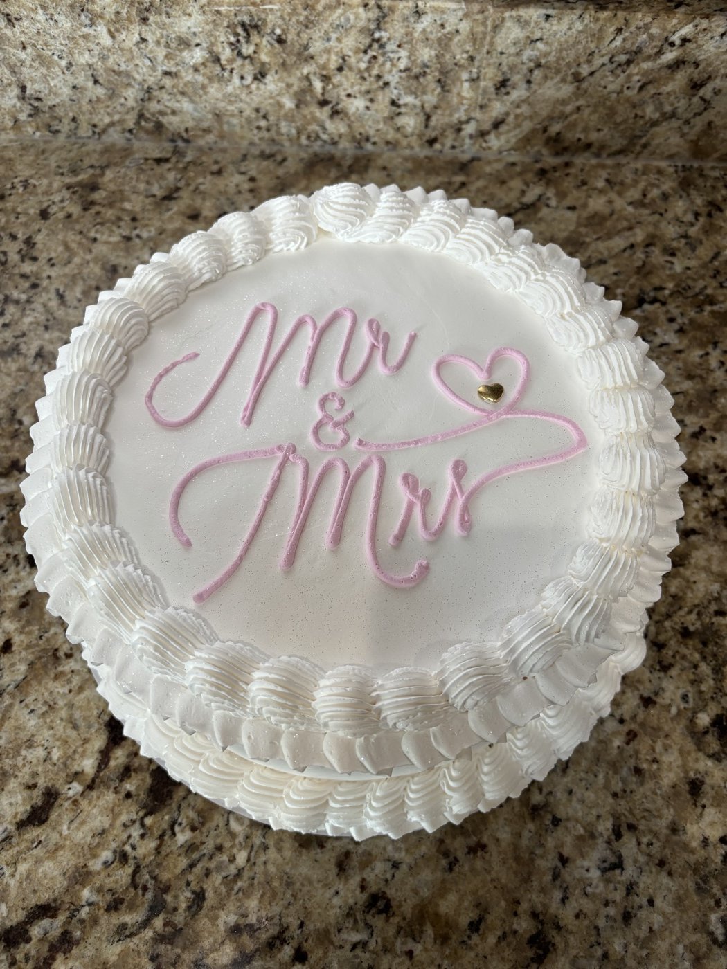 White cake with pink lettering