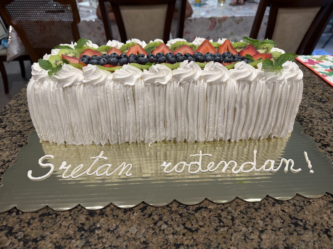 Celebration sheet cake topped with fresh fruit