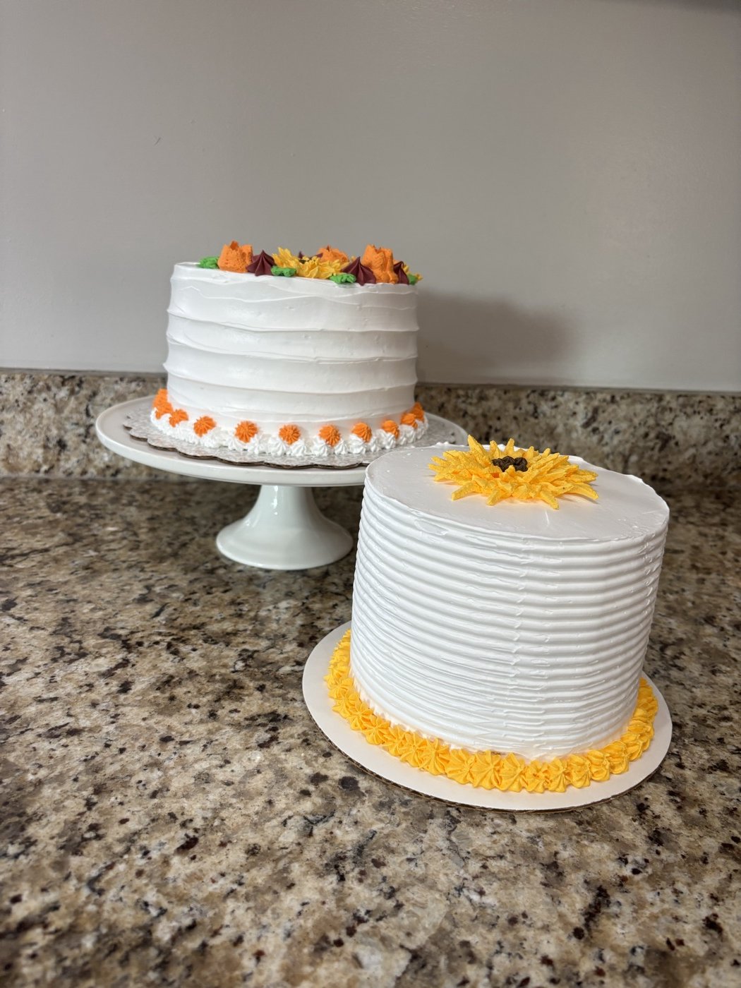 Two flower-decorated cakes