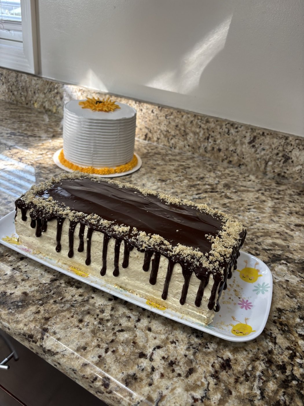 Chocolate drip cake on a white platter