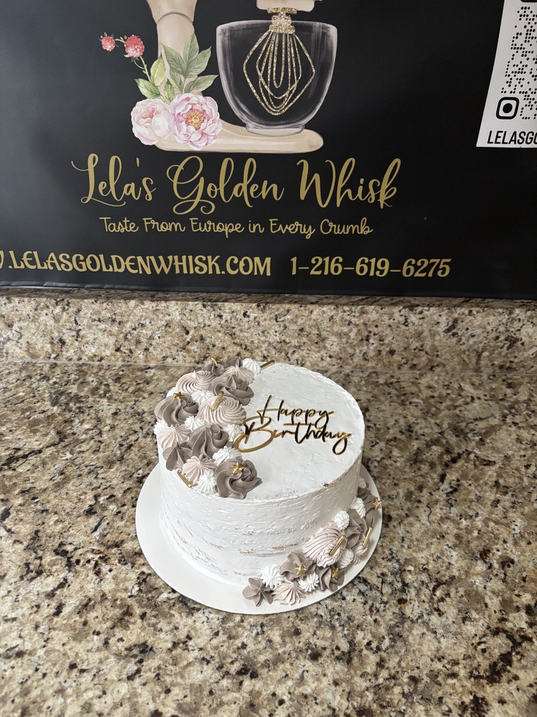 White cake with metallic decorations