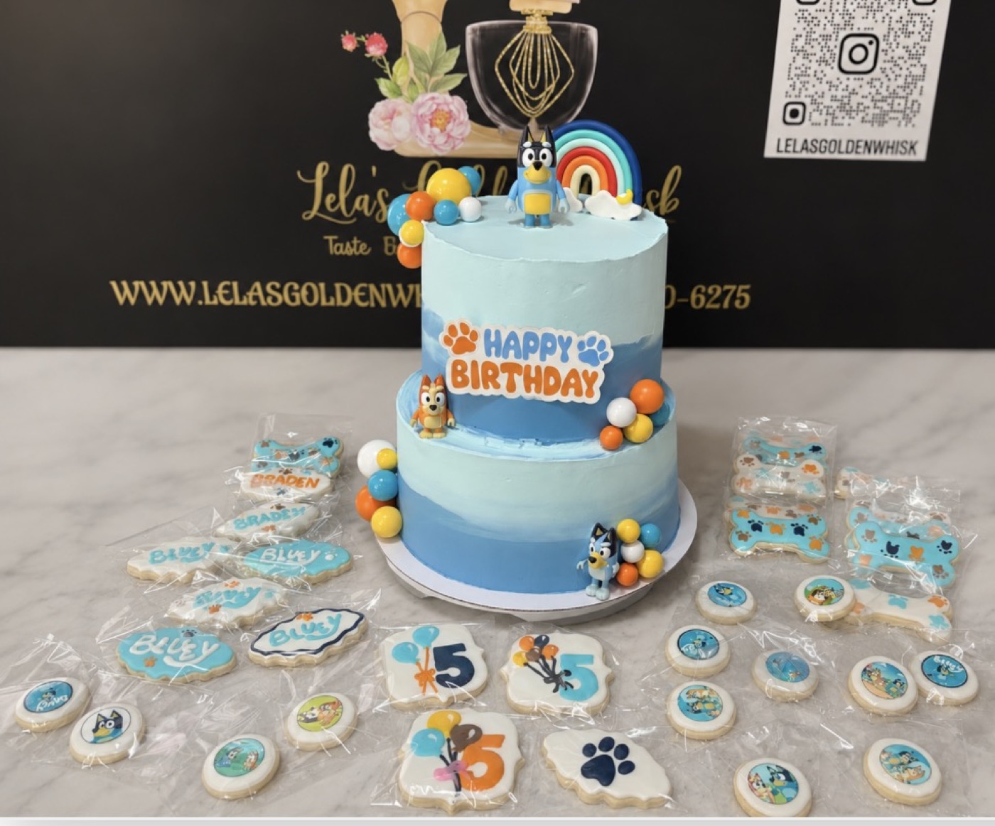 Blue birthday cake with matching cupcakes