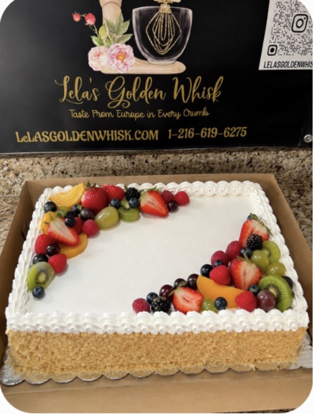 White sheet cake topped with colorful fresh fruit