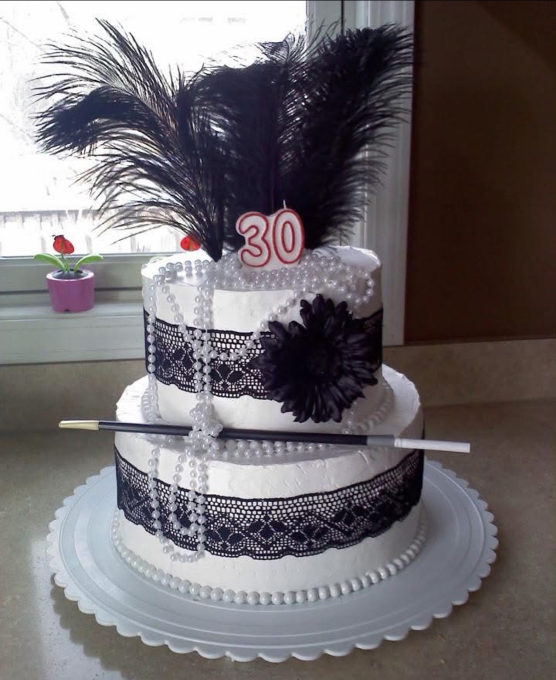 Black and white feather-decorated cake