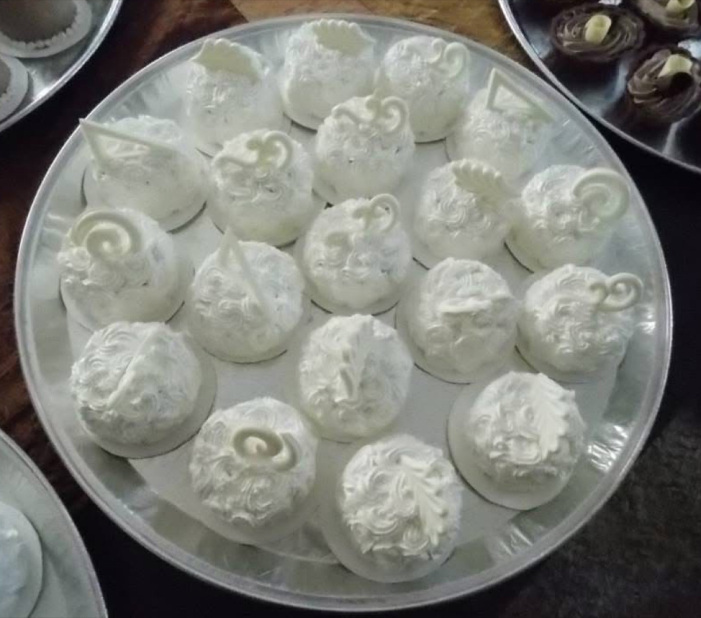 White floral cupcakes on a platter