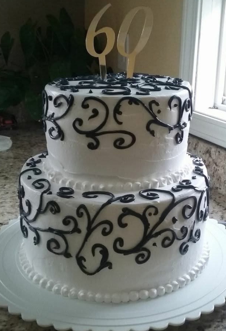 Black and white birthday cake with scrollwork